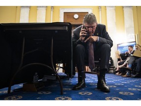 Senator Joe Manchin, a Democrat from West Virginia, talks on the phone prior to a Senate Rules and Administration Committee hearing in Washington, D.C., US, on Wednesday, Aug. 3, 2022. The committee is holding the hearing on bipartisan legislative efforts to ensure another Jan. 6-style push to overturn a presidential election never happens again.