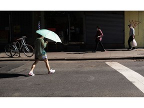 People walk through Chinatown in Manhattan on August 04, 2022.