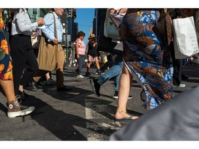 People walk through midtown Manhattan on Aug. 3, 2022.