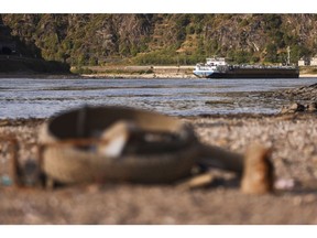 A barge passes exposed riverbed on the Rhine near Loreley, Germany. Photographer: Alex Kraus/Bloomberg