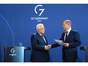 Mahmoud Abbas, Palestinian Authority president, left, and Olaf Scholz, Germany's chancellor, shake hands at the end of a news conference in Berlin, Germany, on Tuesday, Aug. 16, 2022. Scholz and Abbas were speaking following their bi-lateral meeting in the German capital.