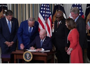 US President Joe Biden signs H.R. 5376, the Inflation Reduction Act of 2022, in the State Dining Room of the White House in Washington, D.C., on Aug. 16. Photographer: Sarah Silbiger/Bloomberg