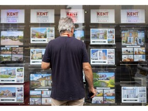 A pedestrian looks at houses for sale in the window of an estate agents in Whitstable, UK, on Tuesday, Aug 16, 2022. Inflation, which is at a 40-year high and set to accelerate, meant the volume of goods purchased declined even as the value of spending increased, the British Retail Consortium said. Photographer: Chris Ratcliffe/Bloomberg