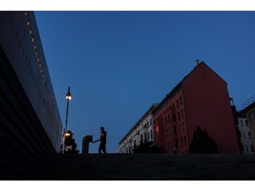 A partially lit apartments block in Berlin. Photographer: Krisztian Bocsi/Bloomberg