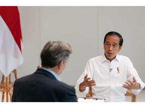 Joko Widodo, Indonesia's president, right, speaks during an interview with John Micklethwait, editor-in-chief of Bloomberg News, at the Hyundai Motor Manufacturing Indonesia in Cikarang, Indonesia, on Thursday, Aug. 18, 2022. Chinese President Xi Jinping and Russian leader Vladimir Putin are both planning to attend a Group of 20 summit in the resort island of Bali later this year, Widodo said.