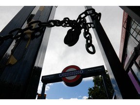 A chain and a lock secure a closed gate at the entrance to Charing Cross Underground Station during a one-day strike by tube workers in London, on Aug. 19. Photographer: Carlos Jasso/Bloomberg