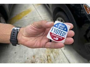 A voter holds an "I Voted" sticker at a polling location in Miami, Florida, on Tuesday, Aug. 23. Photographer: Eva Marie Uzcategui/Bloomberg