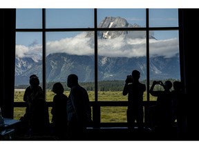 Visitors take photos of the Grand Teton National Park mountain range from Jackson Lake Lodge ahead of the the Jackson Hole economic symposium in Moran, Wyoming, US, on Thursday, Aug. 25, 2022. The Federal Reserve Bank of Kansas City's annual gathering in Jackson Hole, Wyoming, returned to an in-person conference for the first time since the pandemic spread in 2020. Photographer: David Paul Morris/Bloomberg
