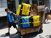 An Amazon worker pulls a cart of packages for delivery in New York City. Amazon said it has 100,000 fewer staff than it did a year ago, adding it’s been adding jobs at the slowest rate since 2019. Photo by Michael M. Santiago/Getty Images