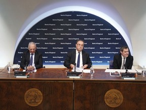 FILE - From left, Jon Cunliffe, Deputy Governor for Financial Stability, Andrew Bailey, Governor of the Bank of England, and James Bell, Executive Director for Communications are seated during the Bank of England's financial stability report press conference, at the Bank of England, London, Tuesday July 5, 2022. The Bank of England is likely to announce its biggest interest rate increase in more than 27 years as it seeks to rein in accelerating inflation driven by the fallout from Russia's invasion of Ukraine.
