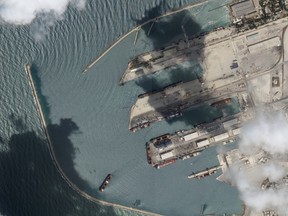 This satellite image from Planet Labs PBC shows the Sierra Leone-flagged cargo ship Razoni, center bottom with four white cranes on its red deck, at port in Tartus, Syria, Monday, Aug. 15, 2022. The first shipment of grain to leave Ukraine under a wartime deal has ended up in Syria, even as that country remains a close ally of Moscow, satellite images analyzed Tuesday by The Associated Press show.
