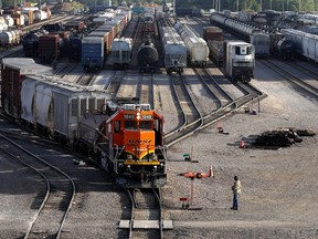 FILE- A BNSF rail terminal worker monitors the departure of a freight train, on June 15, 2021, in Galesburg, Ill. The special board appointed by President Joe Biden to intervene in the stalled railroad contract talks submitted its recommendations to the White House, Tuesday, Aug. 16, 2022, on how to settle the deal that covers 115,000 rail workers and avert a strike, but the details of what those arbitrators suggested weren't immediately available.