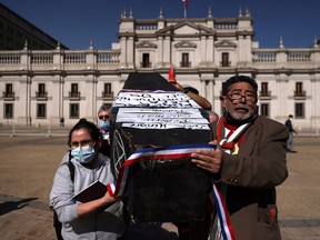 Demonstrators carry a mock-coffin representing the Chilean 80's constitution.