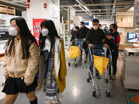 Shoppers wear masks in an Ikea store in Beijing. A store in Shanghai was rapidly locked down after health authorities learned that someone who had been in contact with a COVID-19 patient had visited.