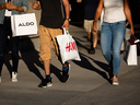 Shoppers walk on Robson Street in Vancouver. Canada's big banks are betting consumers are in good economic shape to weather an expected economic storm.