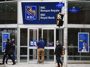 Royal Bank of Canada says its third-quarter profit fell compared with a year ago as it took provisions for potential loan defaults due to a deterioration in its economic outlook. A customer enters an RBC branch in downtown Ottawa on Tuesday, May 3, 2022.