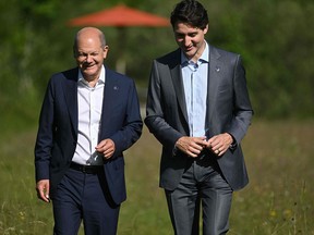 Germany's Chancellor Olaf Scholz, left, and Canada's Prime Minister Justin Trudeau talk during their bilateral meeting at the G7 summit in Germany in June. Scholz will come to Canada Sunday.