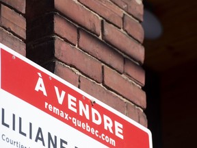 A sign advertising the sale of a house is shown in Montreal, Friday, March 4, 2022.