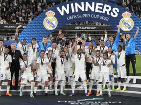 Real Madrid's Karim Benzema lifts the trophy after winning the UEFA Super Cup final soccer match between Real Madrid and Eintracht Frankfurt at Helsinki's Olympic Stadium, Finland, Wednesday, Aug. 10, 2022. Real Madrid won 2-0.