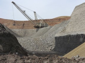 FILE - In this April 4, 2013, file photo, a dragline excavator moves rocks above a coal seam at the Spring Creek Mine in Decker, Mont. A federal judge has reinstated a moratorium on coal leasing from federal lands that was imposed under former President Barack Obama and then scuttled under former President Donald Trump, Friday, Aug. 12, 2022.