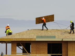 FILE - Work is done on the roof of a building under construction in Sacramento, Calif., Thursday, March 3, 2022. The California Employment Development Department said Friday, Aug. 19, 2022, that the state's unemployment rate was 3.9% in July. That's the lowest since 1976 when the state began using its current method of measuring job growth.