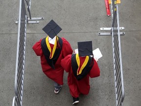 FILE - New graduates walk into the High Point Solutions Stadium before the start of the Rutgers University graduation ceremony in Piscataway Township, N.J., on May 13, 2018. President Joe Biden is expected to announce Wednesday Aug. 24, 2022 that many Americans can have up to $10,000 in federal student loan debt forgiven.