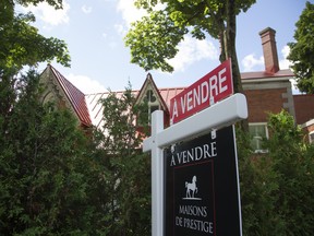 A for-sale sign outside a home in Montreal.