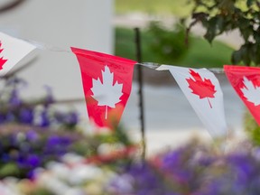 Flags with maple leaves hang outside of the Baitur Rahmat Mosque in Saskatoon, Sask.