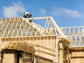 A construction worker works on a new house being built in a suburb located north of Toronto in Vaughan.