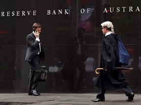 People walk past the Reverse Bank of Australia building in Sydney.