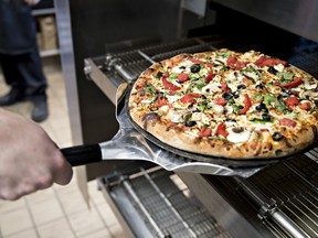 Domino's Pizza Inc. borrowed heavily for plans to open 880 stores, but faced tough competition from local restaurants.
