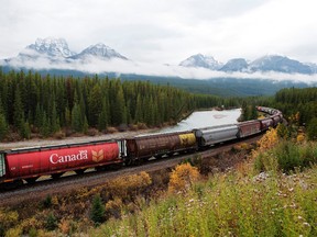 Rail cars loaded with Canadian wheat travel through the Rocky Mountains on the Canadian Pacific Railway Ltd. line near Banff, Alta.