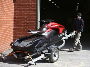 A worker moves a Taiga Motors Corp. electric personal watercraft at the company's facility in LaSalle, Que.