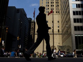 People walk on Bay Street in the financial district of Toronto.