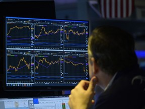 Traders work during the opening bell at the New York Stock Exchange on Wall Street in New York City.