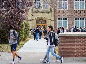 Students exit Western Canada High School at the end of a school day on Oct. 5, 2021.
