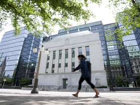 A woman walks past the Bank of Canada headquarters in Ottawa.