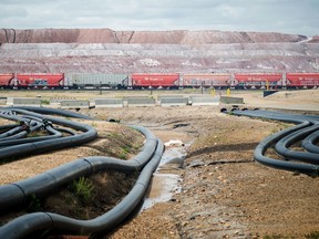 Rail cars sit on tracks in front of a tailings pile at the Nutrien Ltd. Cory potash facility in Saskatoon, Sask.