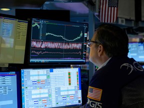 A trader works during the opening bell at the New York Stock Exchange on Wall Street in New York City.