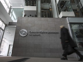 A woman walks inside the Caisse de dépôt et placement du Québec in Montreal.