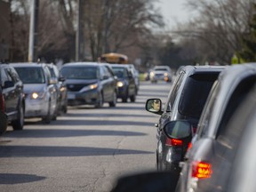 Rows of cars line up as parents drop off their children at Northwood Public School in Brampton, Ont.