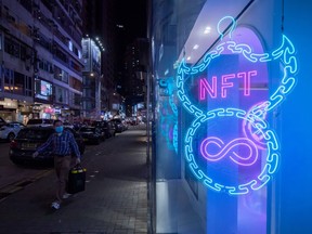 An illuminated neon sign of an NFT displayed in Hong Kong, China.