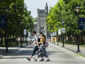 Students who receive scholarships get to spend more time focusing on school and less time working jobs to cover tuition and the cost of living. People walk past the University of Toronto campus in Toronto on Wednesday, June 10, 2020.