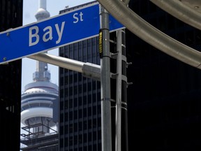 The Bay Street Financial District is shown next to the CN Tower in Toronto on Friday, August 5, 2022.