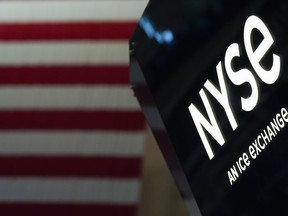 FILE - An NYSE sign is seen on the floor at the New York Stock Exchange in New York, on June 15, 2022. Stocks are opening mostly lower on Wall Street Tuesday, Aug. 16, despite some encouraging results from Walmart and Home Depot, which both beat analysts' forecasts for earnings in the latest quarter.