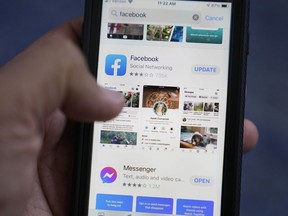 The Facebook app is shown on a smart phone, Friday, April 23, 2021, in Surfside, Fla. As you look through your social media feeds this summer, fear of missing out, or FOMO, can kick in when it seems like everyone you know is strolling through Paris or lounging on a tropical beach.