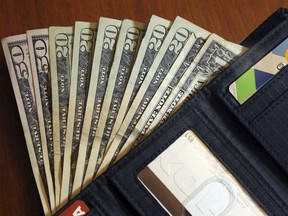 FILE - In this June 15, 2018, file photo, cash is fanned out from a wallet in North Andover, Mass. Whether you want to pay off debt, start a rainy day fund or save for a family trip, budgeting is the first step toward reaching your financial goals. Colleen McCreary of Credit Karma says creating a budget is a lot like trying to eat better or exercise more. Everyone tells you it's good for you, but it's hard to get into the habit.