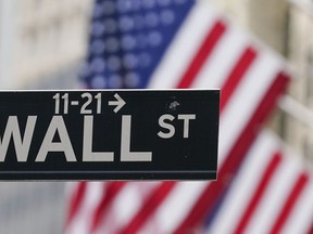 FILE - A Wall Street sign hangs in front of the New York Stock Exchange in New York, on June 14, 2022. Stocks are opening higher on Wall Street Wednesday, Aug. 3.