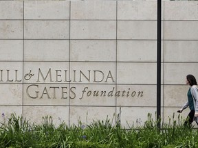 FILE - In this April 27, 2018, file photo, a person walks by the headquarters of the Bill and Melinda Gates Foundation in Seattle. As the Bill & Melinda Gates Foundation works to expand its governance, it announced Thursday, Aug. 18, 2022, that it has added two trustees to its board.