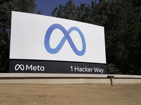 FILE - Facebook's Meta logo sign is seen at the company headquarters in Menlo Park, Calif., on, Oct. 28, 2021. Facebook's corporate parent has reached a tentative settlement, Friday, Aug. 26, 2022, in a lawsuit alleging the world's largest social network service allowed millions of its users' personal information to be fed to Cambridge Analytica, a firm that supported Donald Trump's victorious presidential campaign in 201